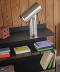 scandinavian bookshelf with beam lamp by muuto in polished aluminum 