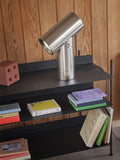 scandinavian bookshelf with beam lamp by muuto in polished aluminum 