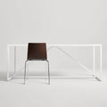 Blu Dot Chair Chair in Graphite on Oak rear view styled with a white Strut dining table on white background