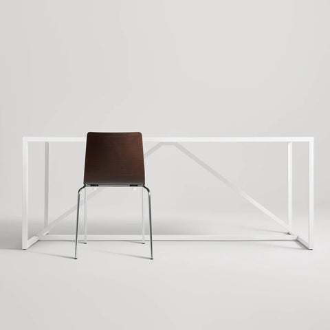 Blu Dot Chair Chair in Graphite on Oak rear view styled with a white Strut dining table on white background