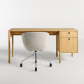 Blu Dot Cursive Desk in white oak rear view showing round cutout drawer pulls with Host task chair on white background