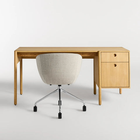 Blu Dot Cursive Desk in white oak rear view showing round cutout drawer pulls with Host task chair on white background