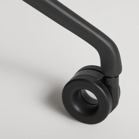 Blu Dot Clean Cut Task Chair close-up detail of the black powder-coated aluminum leg and caster wheel