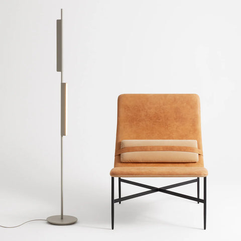 Blu Dot Cowl Floor Lamp in putty finish, 62" tall powder-coated aluminum floor lamp with two pivoting shades, styled beside a tan leather lounge chair
