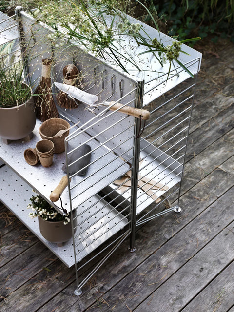 Vertical Double Hook by String™ System in stainless steel mounted on galvanized shelving, holding garden tools and accessories outdoors