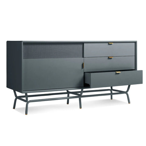 Blu Dot Dang 1 Door / 3 Drawer Console in marine blue painted oak veneer with matching perforated steel door front, antique brass pulls, and powder-coated steel legs, shown at an angle with one drawer open