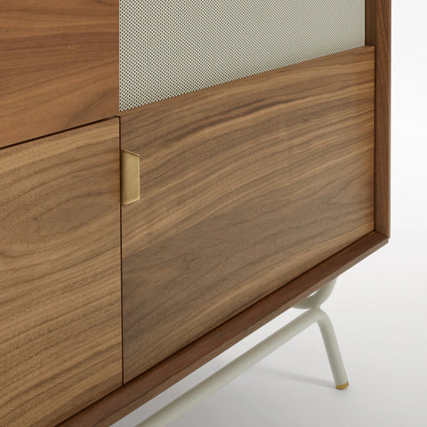 Blu Dot Dang 2 Door / 2 Drawer Console close-up detail in walnut veneer with perforated grey steel door fronts, antique brass pulls, and putty powder-coated steel legs