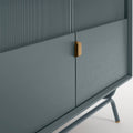 Blu Dot Dang Media Stand close-up detail in marine blue painted oak veneer with matching perforated steel door front, antique brass pull, and powder-coated steel leg
