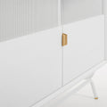 Blu Dot Dang Media Stand close-up detail in white painted oak veneer with matching perforated steel door front, antique brass pull, and white powder-coated steel leg