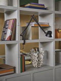 muuto stacked storage syustem and clamped office lamp