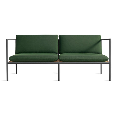Blu Dot Dog Days Outdoor 2 Seat Sofa in Sunbrella Ivy green cushions with charcoal powder-coated aluminum frame and all-weather rattan