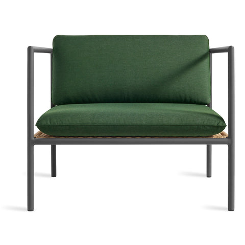 Blu Dot Dog Days Outdoor Lounge Chair in Sunbrella Ivy green cushions with charcoal powder-coated aluminum frame and all-weather rattan