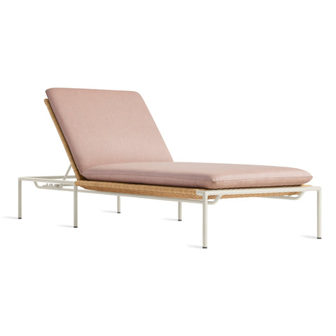 Blu Dot Dog Days Outdoor Sun Lounger in Sunbrella Blush pink cushion with white powder-coated aluminum frame and all-weather rattan