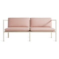 Blu Dot Dog Days Outdoor 2 Seat Sofa in Sunbrella Blush pink cushions with white powder-coated aluminum frame and all-weather rattan