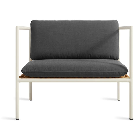 Blu Dot Dog Days Outdoor Lounge Chair in Sunbrella Coal black cushions with white powder-coated aluminum frame and all-weather rattan