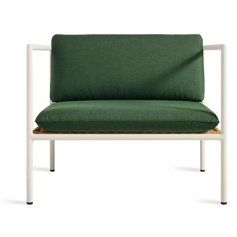 Blu Dot Dog Days Outdoor Lounge Chair in Sunbrella Ivy green cushions with white powder-coated aluminum frame and all-weather rattan