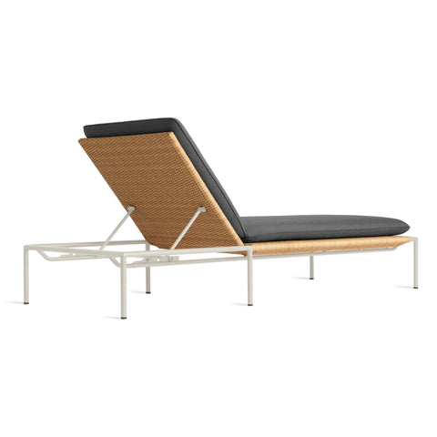 Blu Dot Dog Days Outdoor Sun Lounger in Sunbrella Coal black cushion with white powder-coated aluminum frame and all-weather rattan, shown from the back angle with backrest raised to display the adjustable reclining mechanism and woven rattan panel