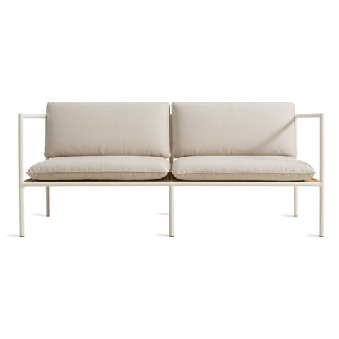 Blu Dot Dog Days Outdoor 2 Seat Sofa in Sunbrella Linen cushions with white powder-coated aluminum frame and all-weather rattan