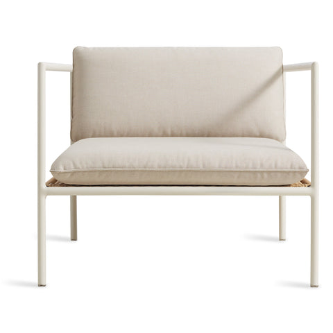 Blu Dot Dog Days Outdoor Lounge Chair in Sunbrella Linen cushions with white powder-coated aluminum frame and all-weather rattan