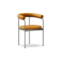 DK3 Baia dining chair fully upholstered in Rio Cognac 2488 leather with a black steel frame, angled view on a white background