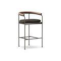 DK3 Baia Counter Stool in Rio Leather Black 0500, upholstered counter stool with walnut back and black steel frame, angled view on white