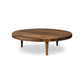 DK3 Groove Coffee Table in Smoked Oak, round solid oak coffee table with a grooved edge and tapered legs, side view on white