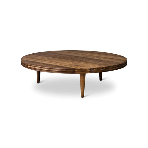 DK3 Groove Coffee Table in Smoked Oak, round solid oak coffee table with a grooved edge and tapered legs, side view on white