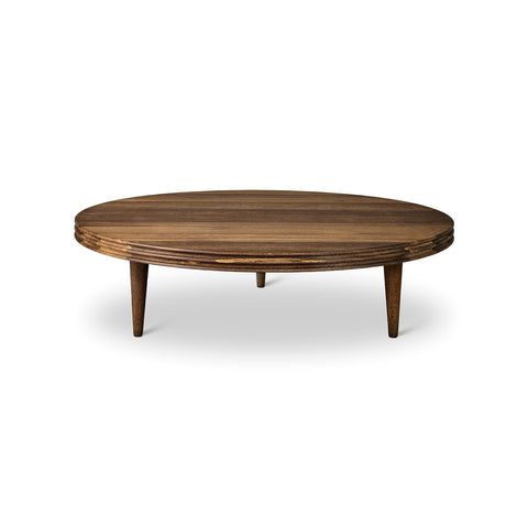 DK3 Groove Coffee Table in Smoked Oak, round solid oak coffee table with a grooved edge and tapered legs, angled view on white