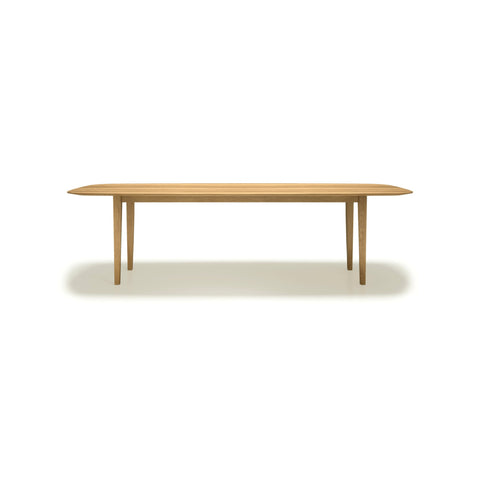 DK3 Kia's Table in Oiled Oak, four-leg solid wood dining table with a sloping edge, front view on white