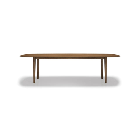 DK3 Kia's Table in Smoked Oak, four-leg solid wood dining table with a sloping edge, front view on white