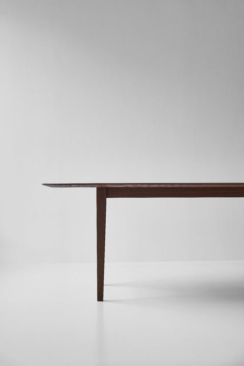 DK3 Kia's Table in smoked oak, corner of the table showing the tapered leg