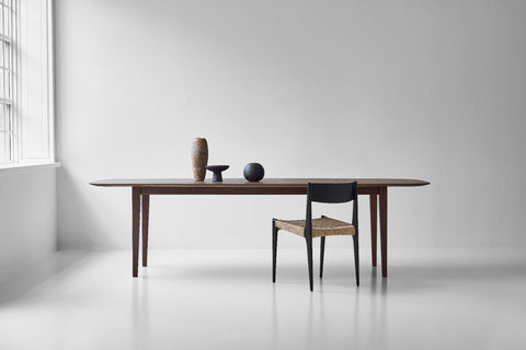 DK3 Kia's Table in smoked oak with a paper cord chair in a white room