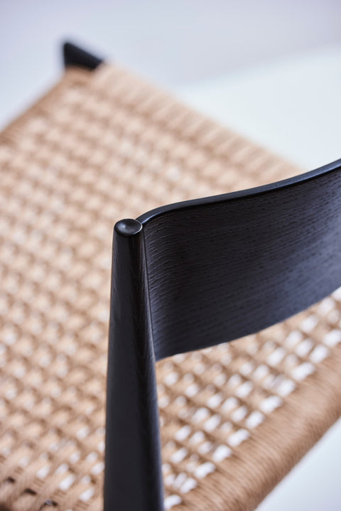 DK3 Pia Chair in black lacquered oak, close view of the backrest and paper cord seat