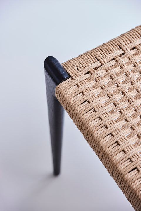 DK3 Pia Chair in black lacquered oak, close view of the leg and hand-woven paper cord