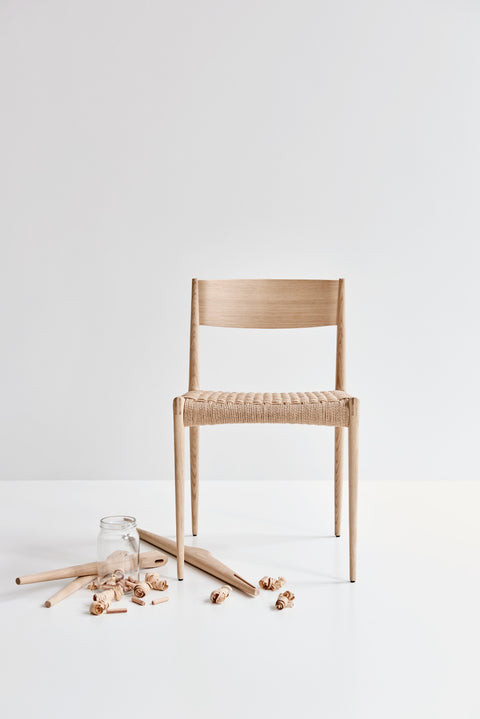 DK3 Pia Chair in soaped oak with a natural paper cord seat and wood shavings on the floor