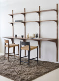 DK3 Pia Counter Stools at a System Cado desk on a rug, one in smoked oak and one in black lacquered oak