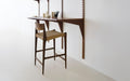 DK3 Pia Counter Stool in smoked oak at a wall mounted System Cado desk