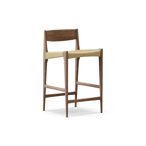 DK3 Pia Counter Stool in Walnut, wooden counter stool with a natural paper cord seat and footrest, angled view on white