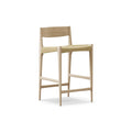 DK3 Pia Counter Stool in White Oiled Oak, wooden counter stool with a natural paper cord seat and footrest, angled view on white