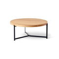 DK3 Plateau Coffee and Side Table in Oiled Oak, round solid oak coffee table on a black steel tripod base, front view on white