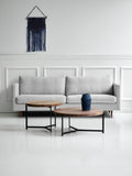 DK3 Plateau Coffee and Side Table in walnut, two round tables on black steel bases in front of a pale sofa