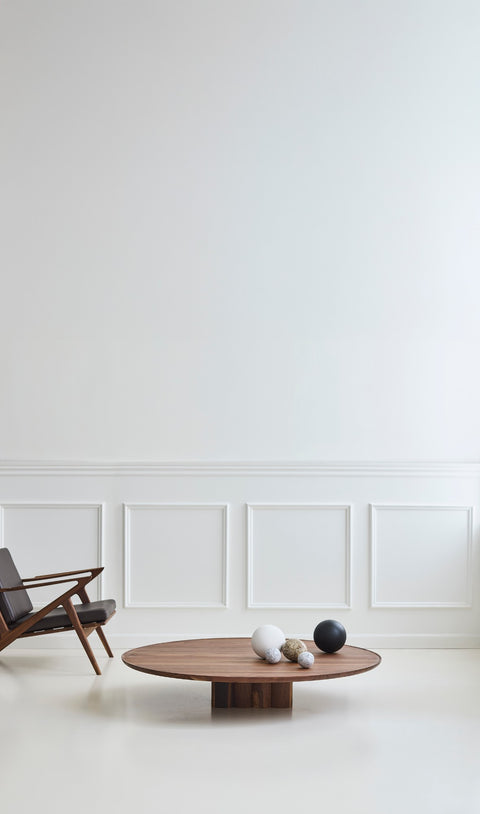 DK3 Plush Coffee Table in smoked oak beside a lounge chair