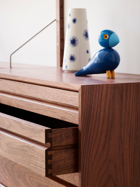 DK3 Royal System walnut cabinet with three drawers, open, with a bird figure and a vase on top