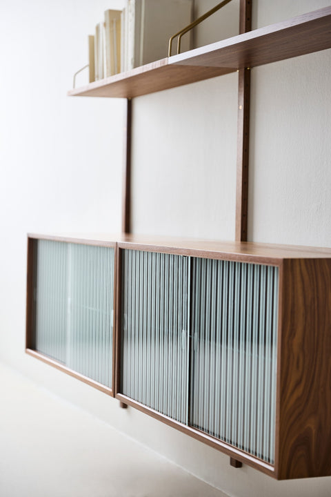DK3 Royal System walnut cabinet with sliding rippled glass doors, angled view