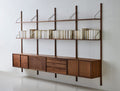 DK3 Royal System walnut rails with shelves and a row of cabinets, angled view