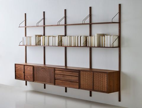 DK3 Royal System walnut rails with shelves and a row of cabinets, angled view