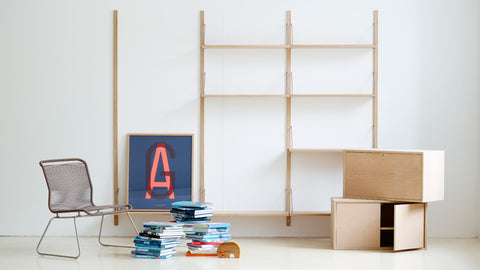 DK3 Royal System shelves in soaped oak with a wire chair, a print and magazines