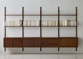 DK3 Royal System walnut shelves lined with books above walnut cabinets
