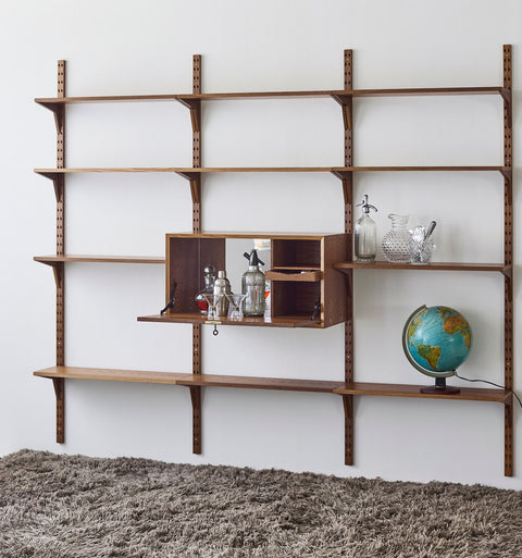 DK3 System Cado smoked oak drop-front cabinet with mirror and shelf, open, beside a globe