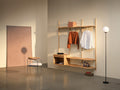 DK3 System Ultra oiled oak wall system with a clothes rail, shelves and a floor lamp